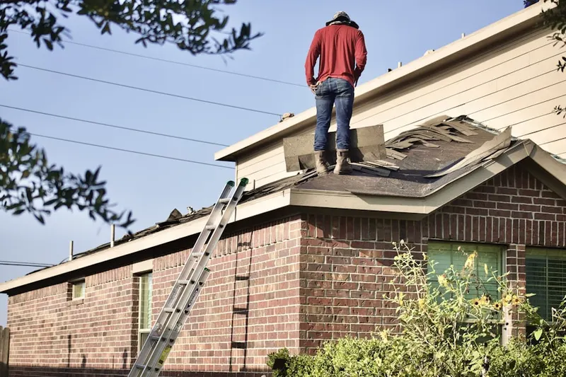 Professional roofer working on a residential roof in Pylesville